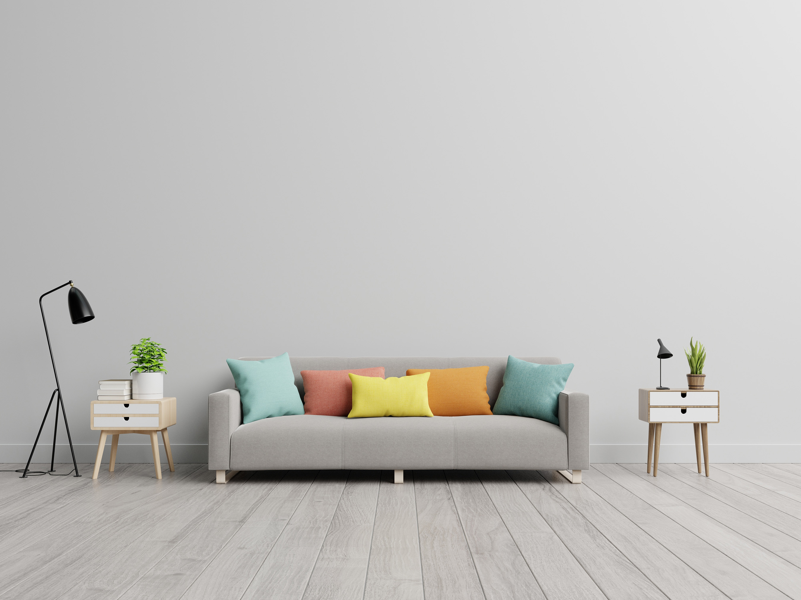 grey couch with colorful throw pillows in a large room